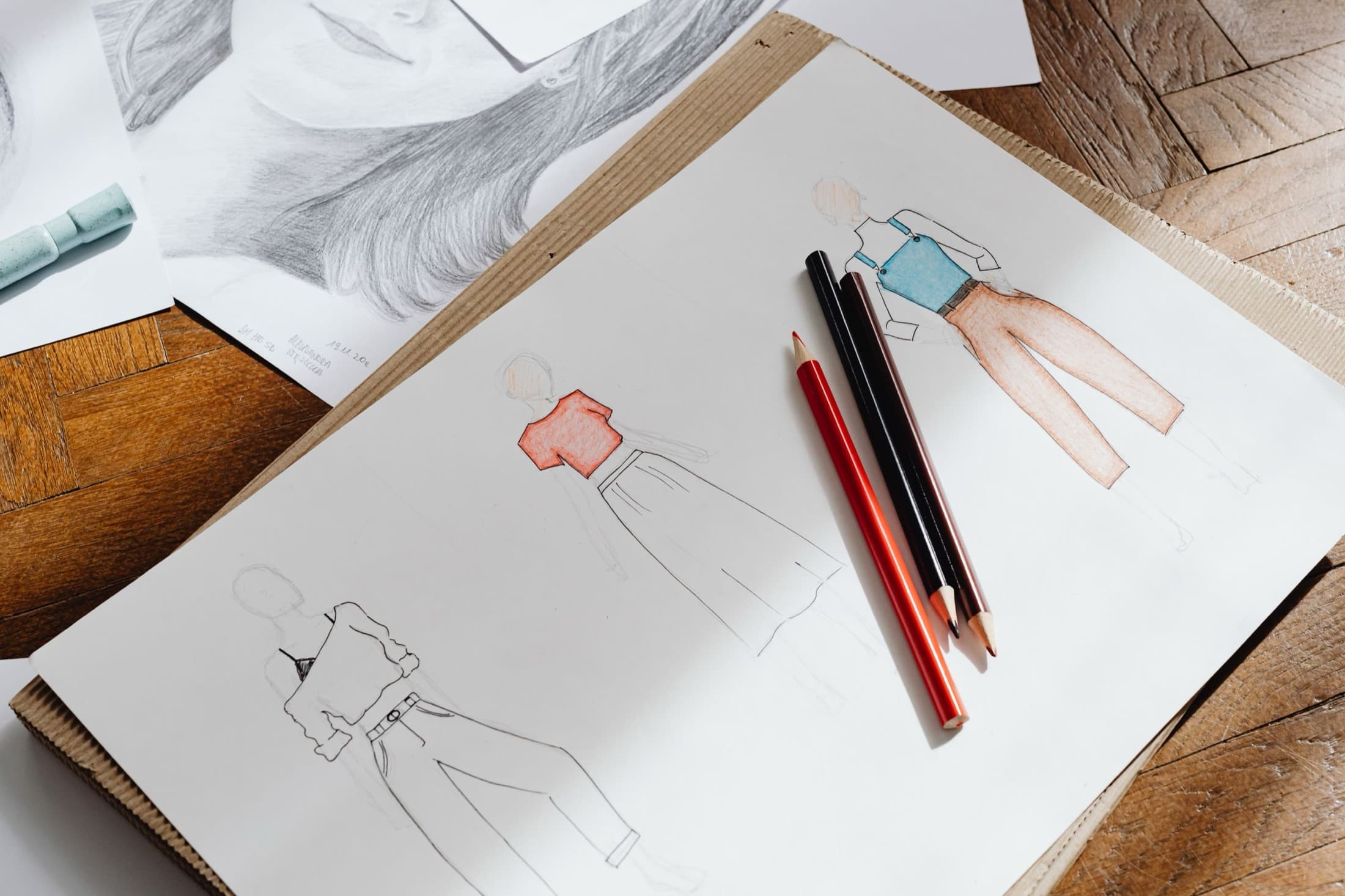 Fashion design sketches with coloured pencils